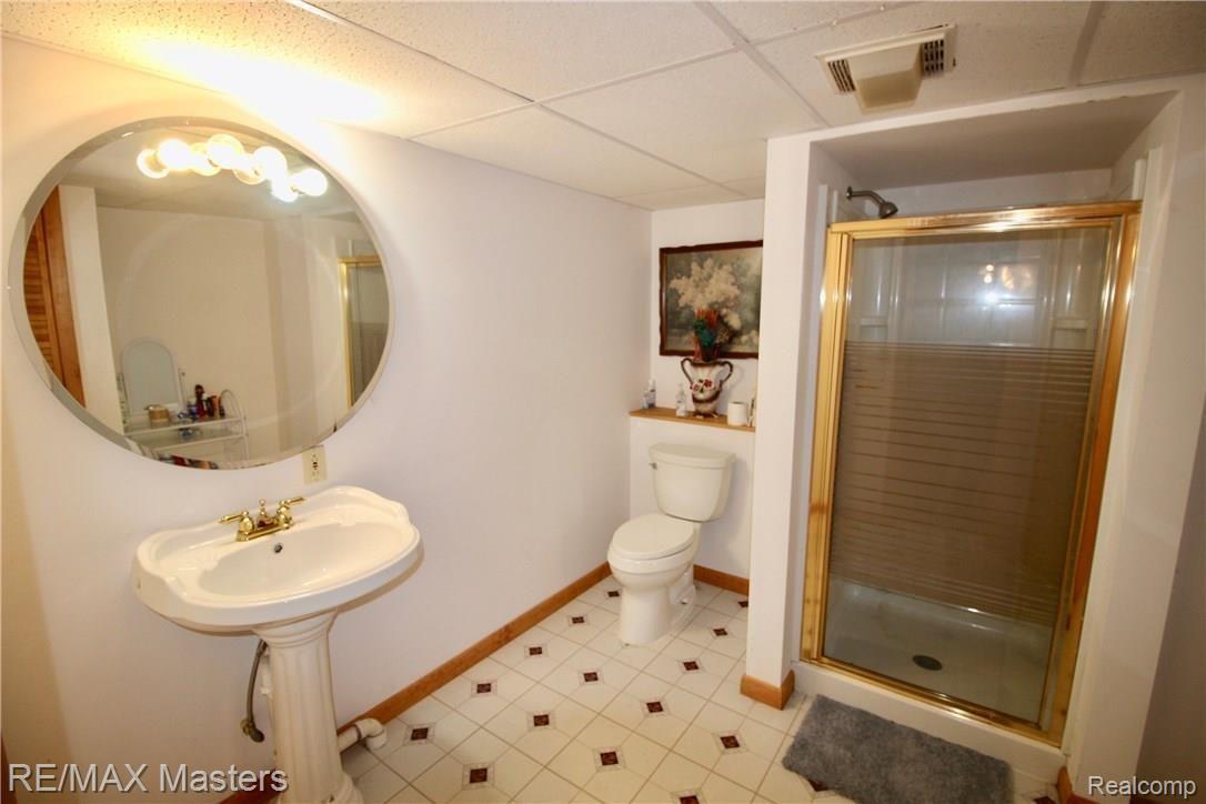 26454 Rinne Road New Boston, MI 48164 - Photo 27 of 41 Basement bathroom has walk in shower, pedestal sink and good lighting!