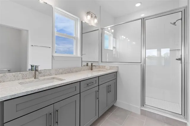 a bathroom with a granite countertop sink mirror and double