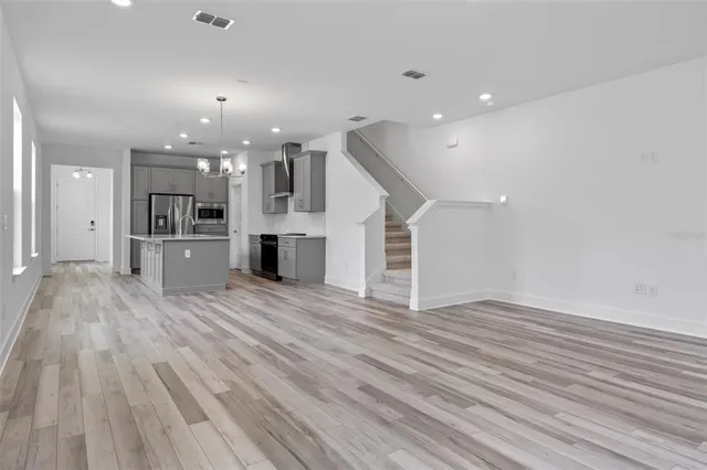 a view of a kitchen with a wooden floor and a kitchen