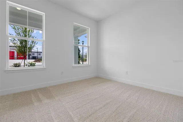 an empty room with windows and entrance