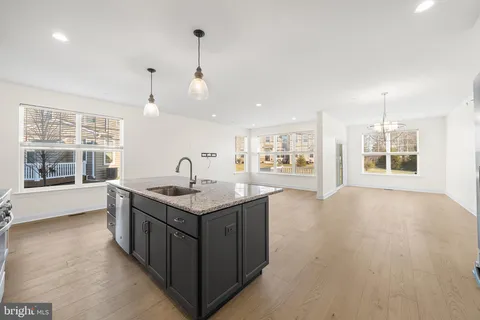 a kitchen with stainless steel appliances granite countertop a sink and stove