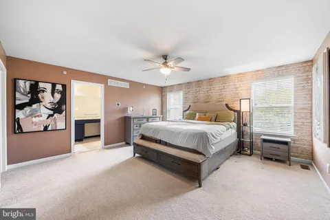a bedroom with a bed and a ceiling fan