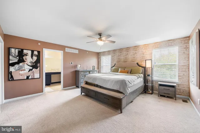 a bedroom with a bed and a ceiling fan