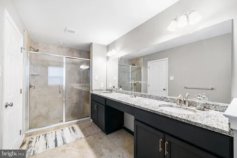 a bathroom with a granite countertop sink mirror and double