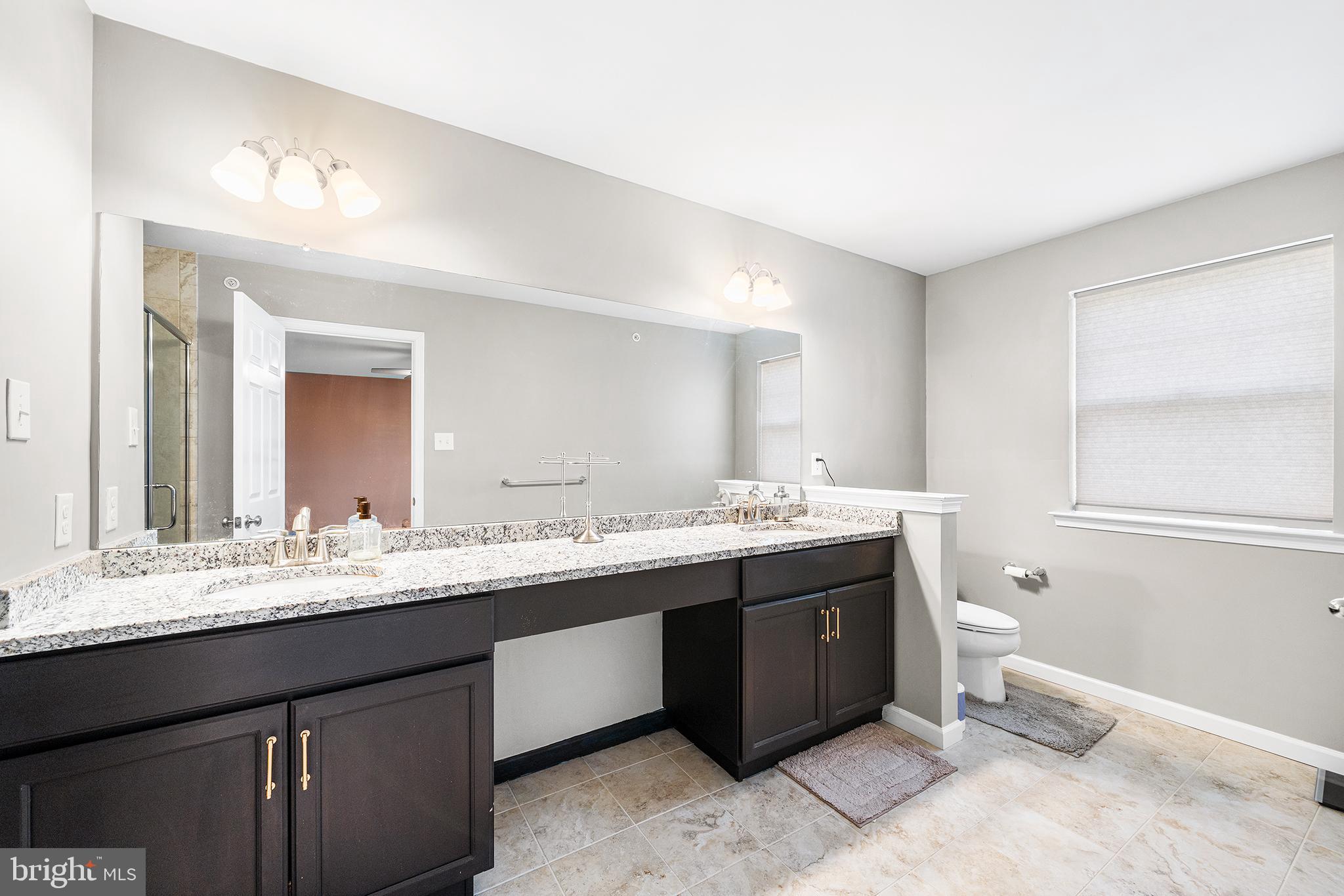186 Spring Lane Royersford, PA 19468 - Photo 19 of 29 a bathroom with a double vanity sink and a mirror