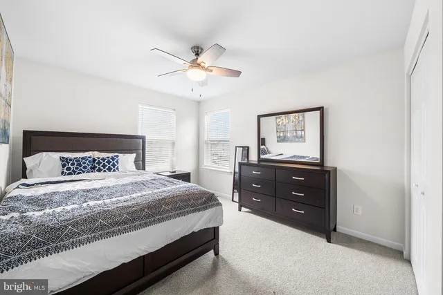 a bedroom with a bed and a mirror