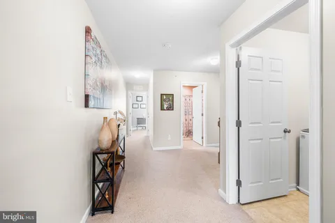 wooden floor with white walls and stairs