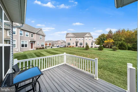 a view of a chair and table on the wooden deck