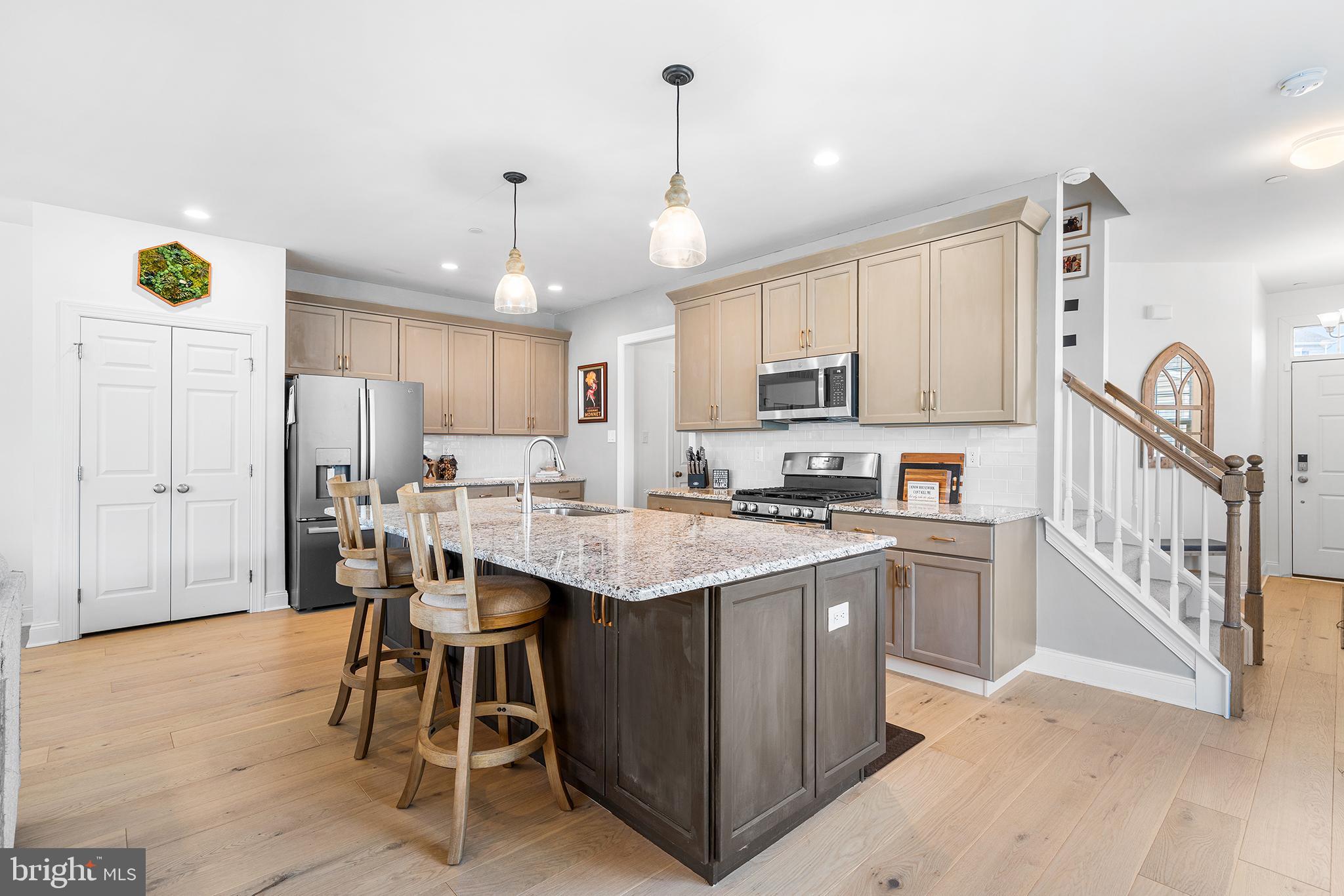186 Spring Lane Royersford, PA 19468 - Photo 5 of 29 a kitchen with stainless steel appliances kitchen island granite countertop a table chairs and a refrigerator