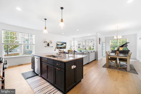 a kitchen with a sink and view of living room
