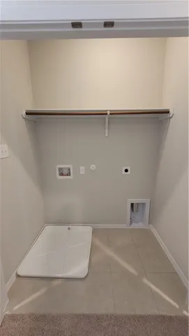 a view of a utility room with shelf