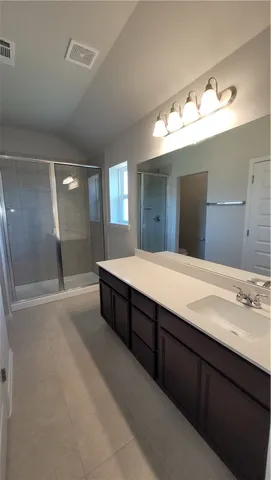 a spacious bathroom with a double vanity sink and a mirror