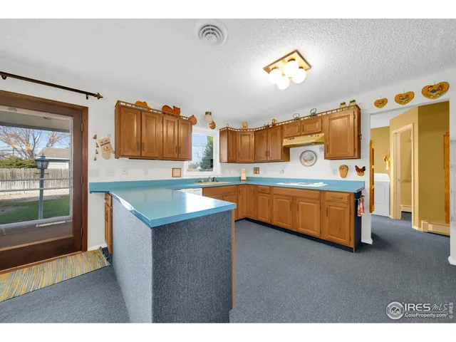 a kitchen with stainless steel appliances granite countertop a sink and a wooden cabinets