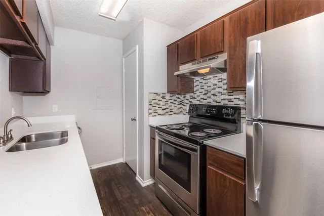 a kitchen with a stove and a refrigerator