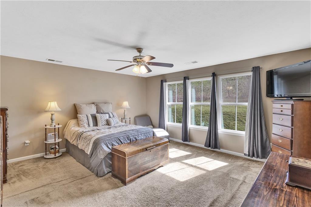 7787 Dominick Drive Irwin, PA 15642 - Photo 23 of 35 a spacious bedroom with a large bed and a flat tv screen on dresser
