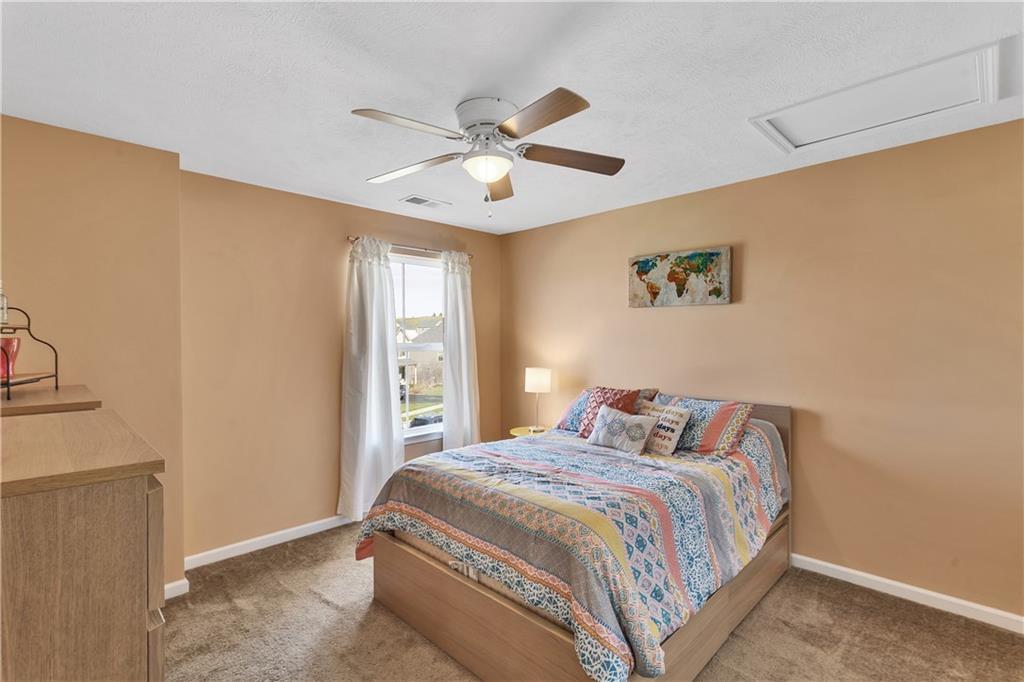 7787 Dominick Drive Irwin, PA 15642 - Photo 29 of 35 a bedroom with a bed and a chandelier