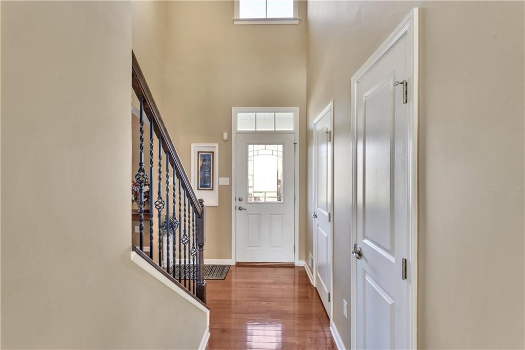 7787 Dominick Drive Irwin, PA 15642 - Photo 7 of 35 a view of a hallway with wooden floor and staircase