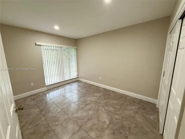 a bathroom with a granite countertop toilet a sink a mirror and shower