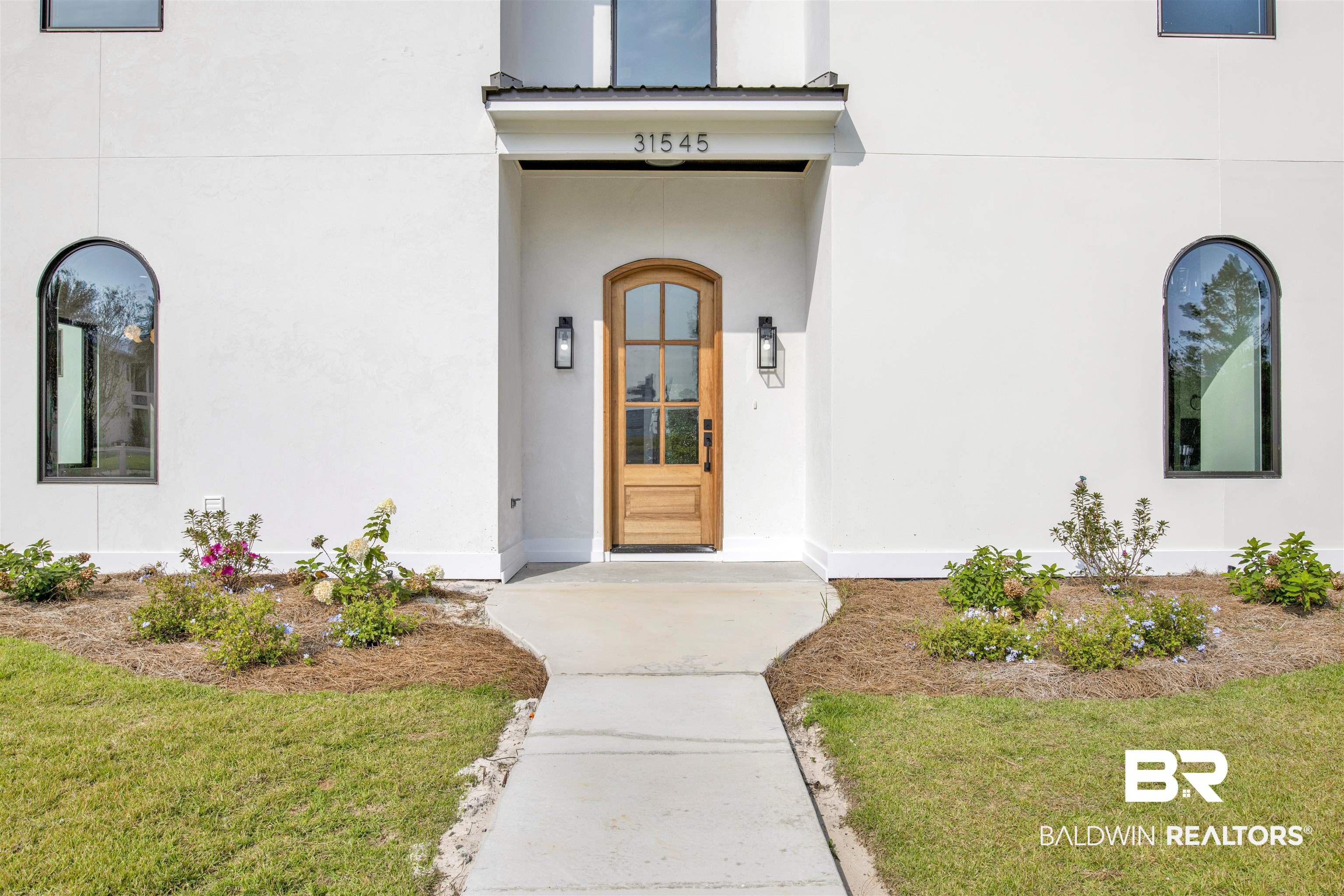 31545 River Road Orange Beach, AL 36561 - Photo 10 of 59 View of exterior entry with a lawn