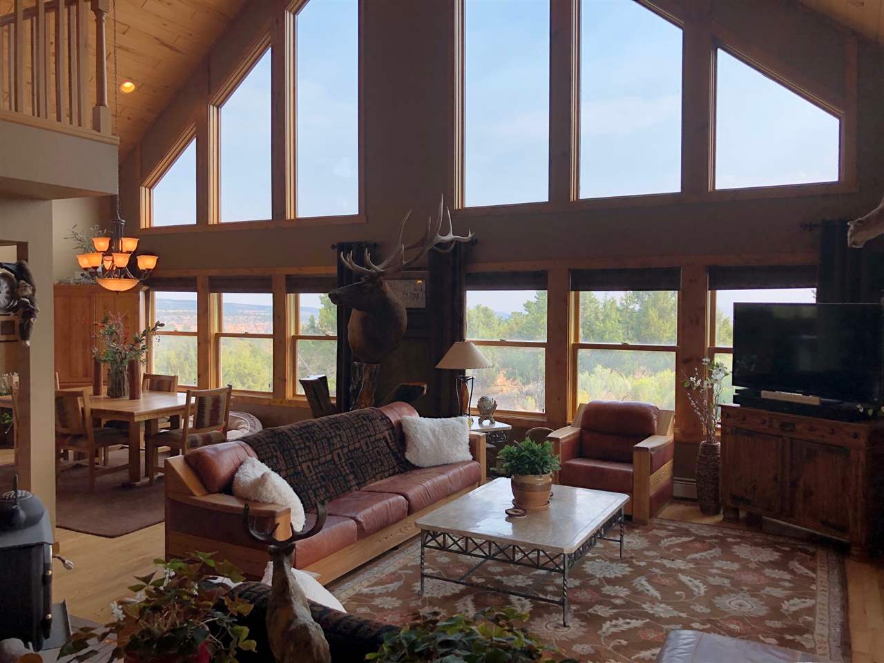 a living room with furniture fireplace and large windows