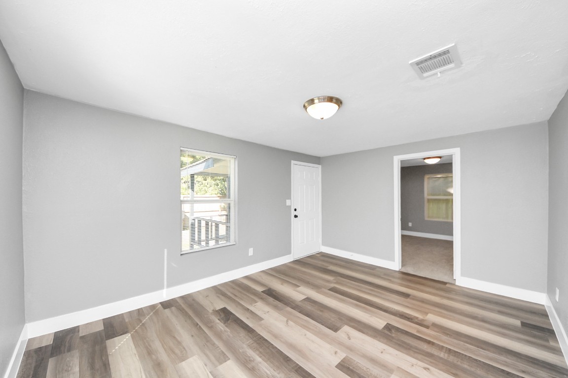 3206 Melbourne Street Houston, TX 77026 - Photo 18 of 41 a view of empty room with wooden floor and fan