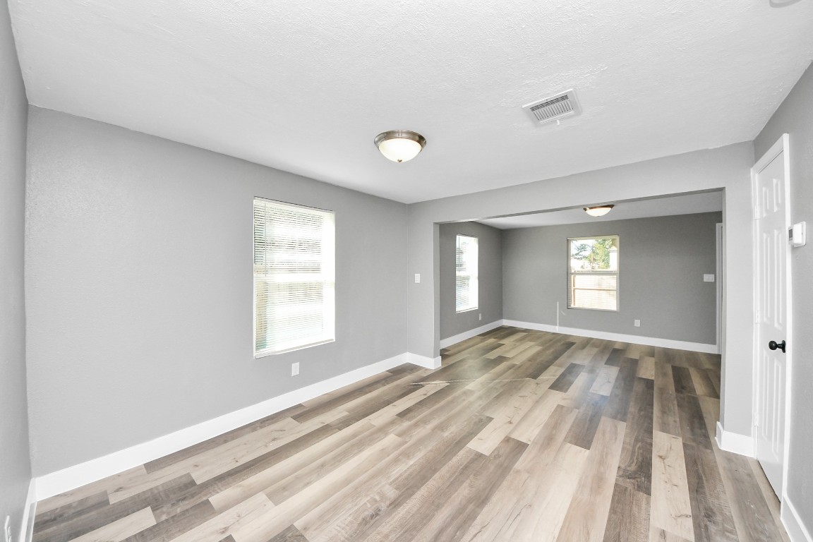 3206 Melbourne Street Houston, TX 77026 - Photo 21 of 41 a view of an empty room and window and wooden floor