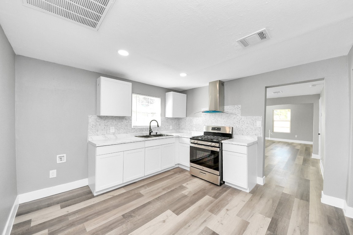 3206 Melbourne Street Houston, TX 77026 - Photo 24 of 41 a kitchen with stainless steel appliances granite countertop a stove and a sink