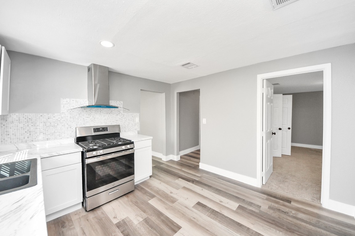 3206 Melbourne Street Houston, TX 77026 - Photo 25 of 41 a kitchen with a stove and a sink
