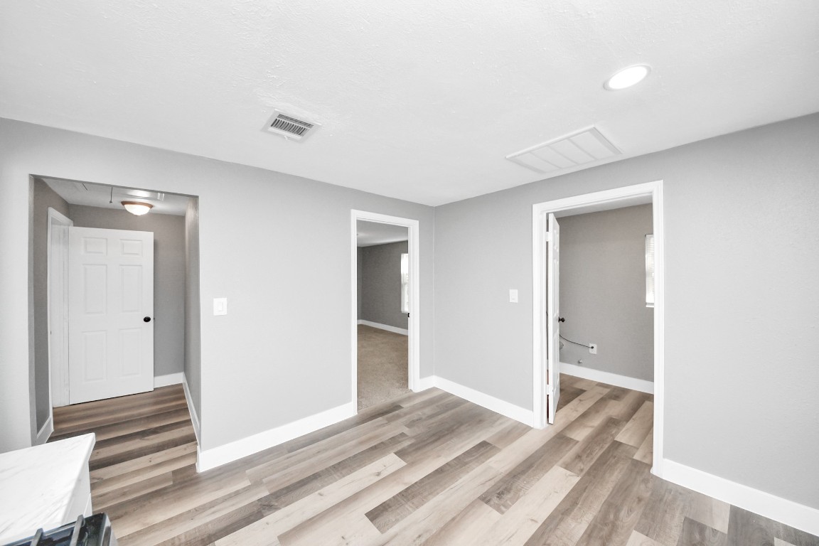 3206 Melbourne Street Houston, TX 77026 - Photo 27 of 41 a view of a bedroom with wooden floor & bathroom