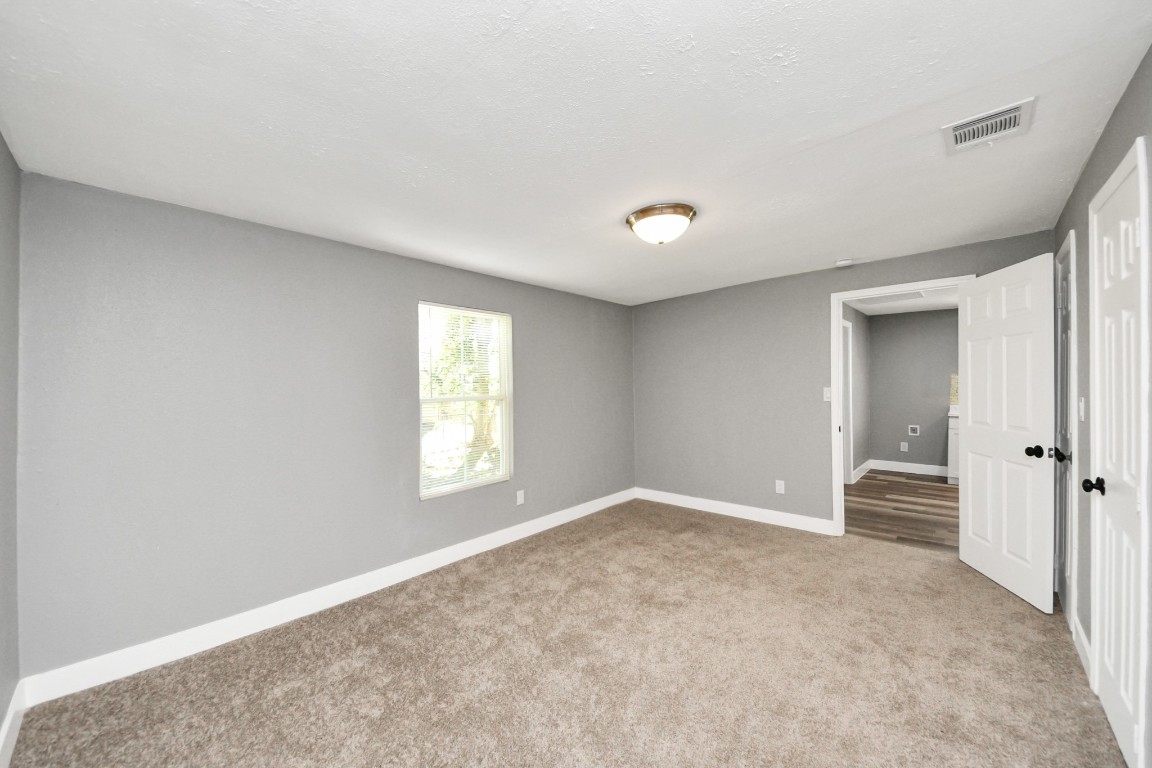 3206 Melbourne Street Houston, TX 77026 - Photo 33 of 41 a view of an empty room with wooden floor and a window