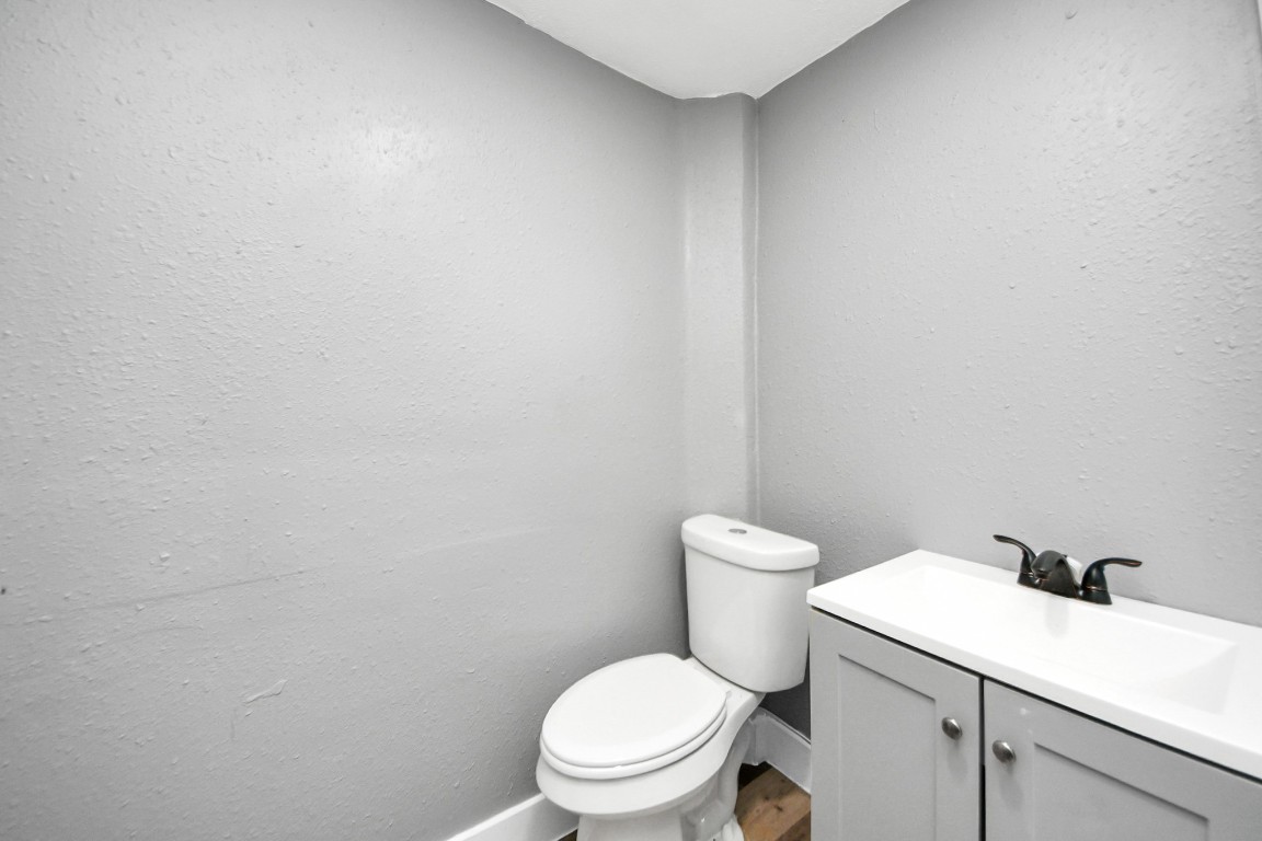 3206 Melbourne Street Houston, TX 77026 - Photo 36 of 41 a white toilet sitting next to a white sink and vanity