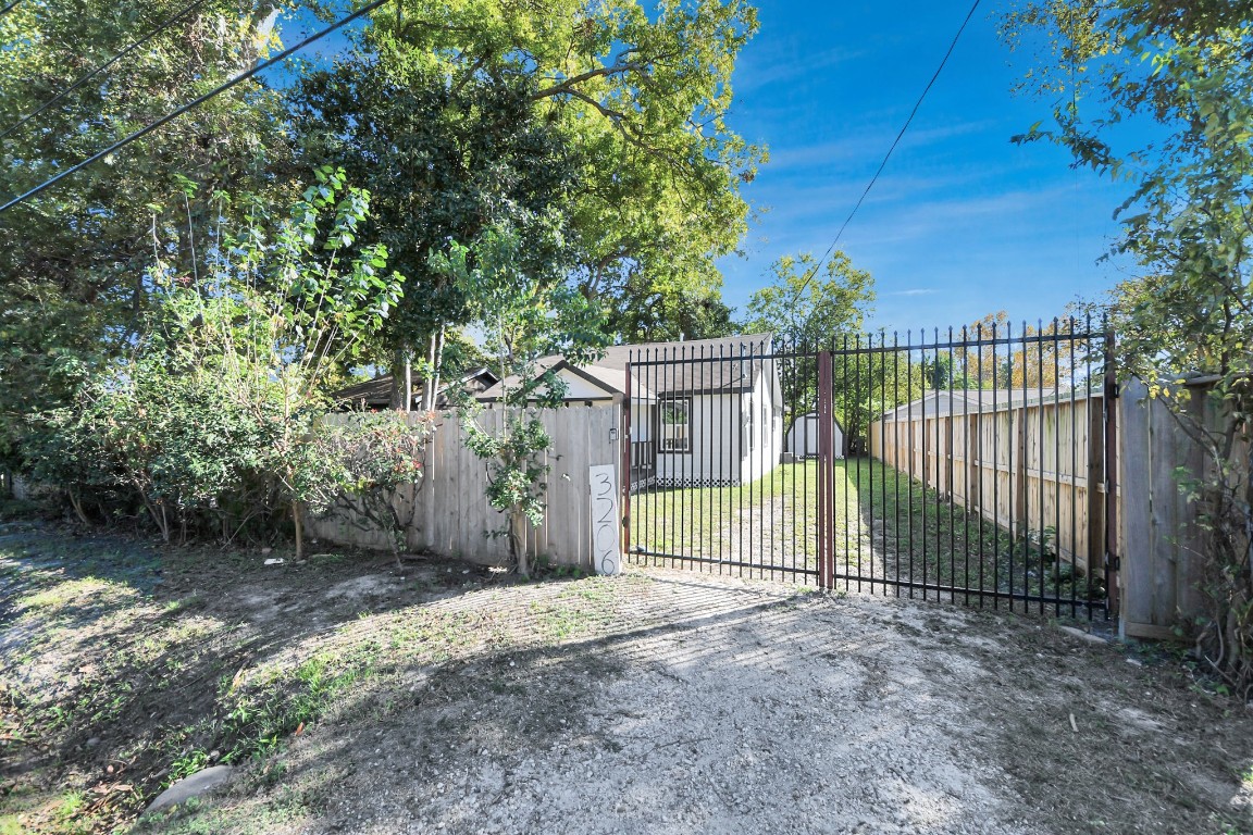 3206 Melbourne Street Houston, TX 77026 - Photo 8 of 41 a view of a house with a backyard and a tree