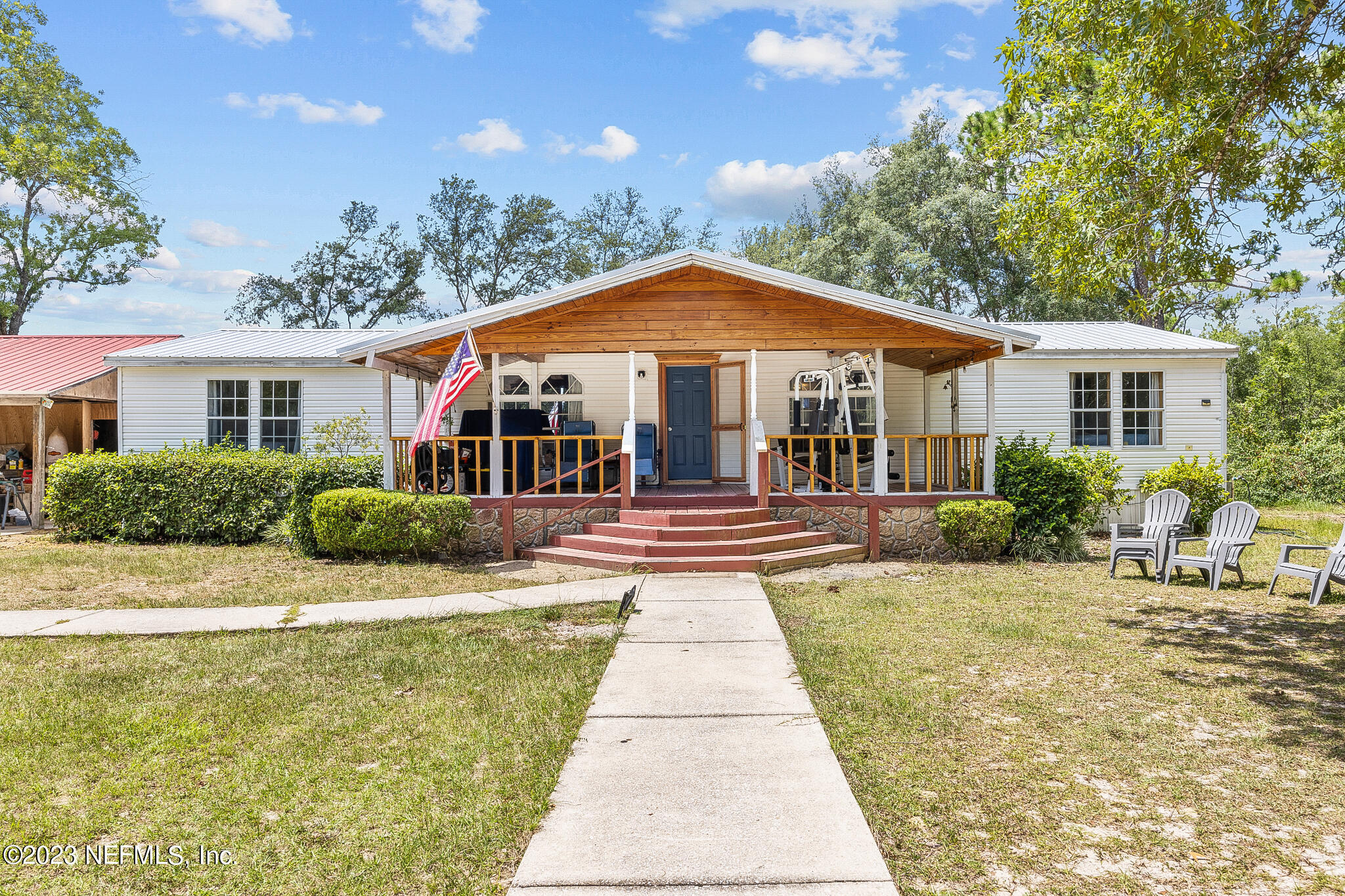 a front view of a house with yard patio and green space