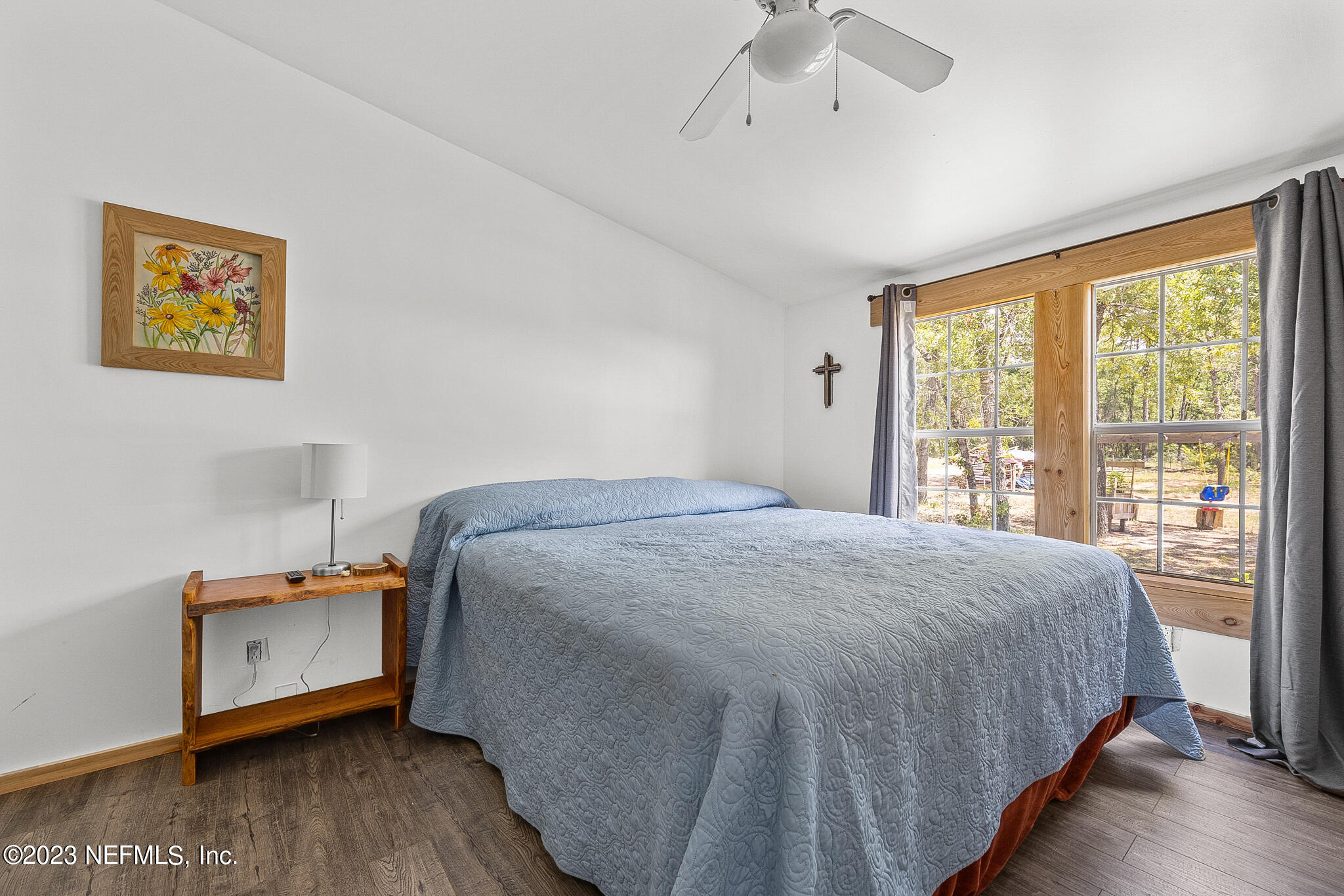 7730 Ranchette Road Keystone Heights, FL 32656 - Photo 14 of 30 a bedroom with a bed and a large window