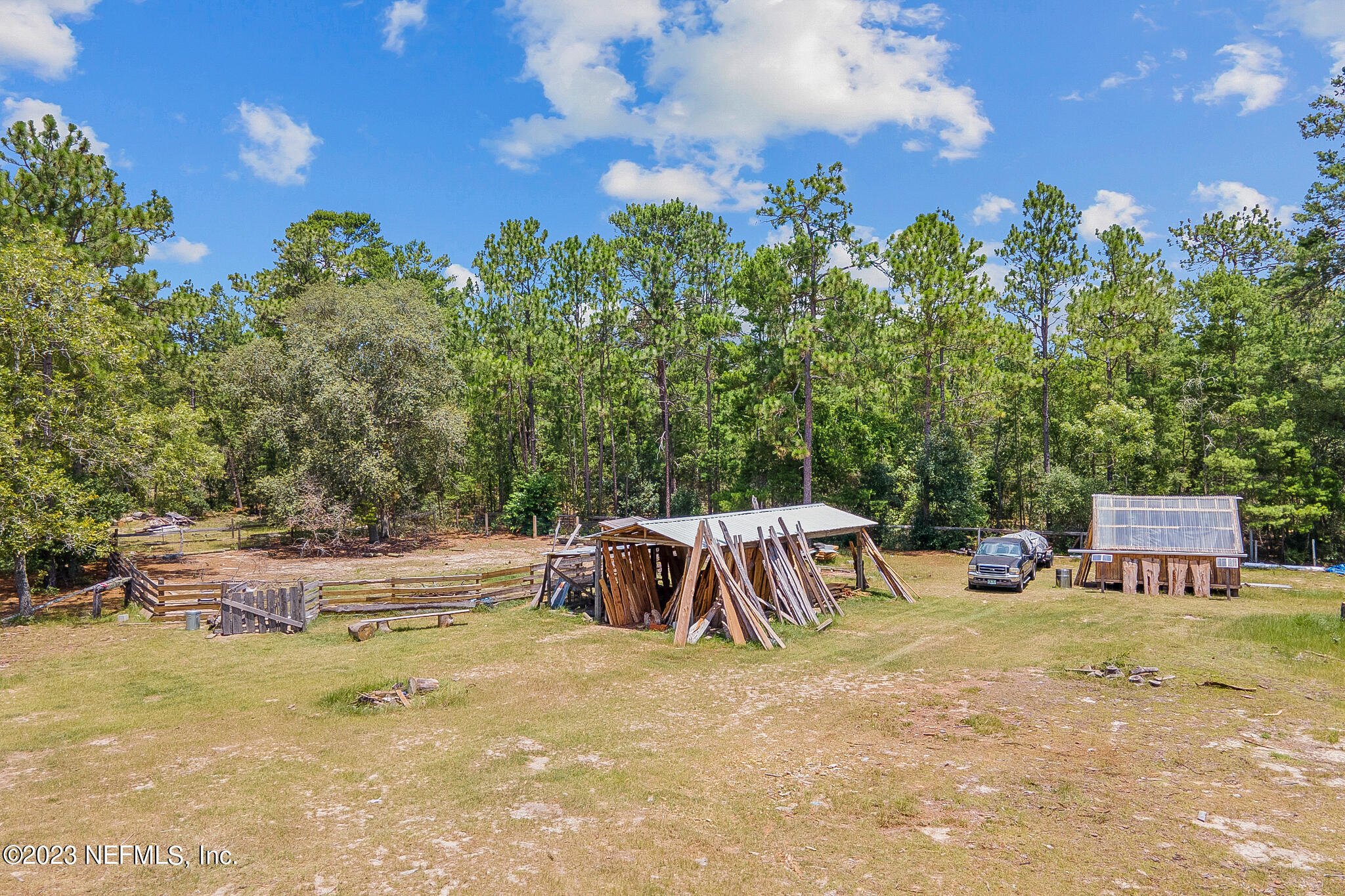 7730 Ranchette Road Keystone Heights, FL 32656 - Photo 22 of 30 a view of a swimming pool with lawn chairs and a big yard