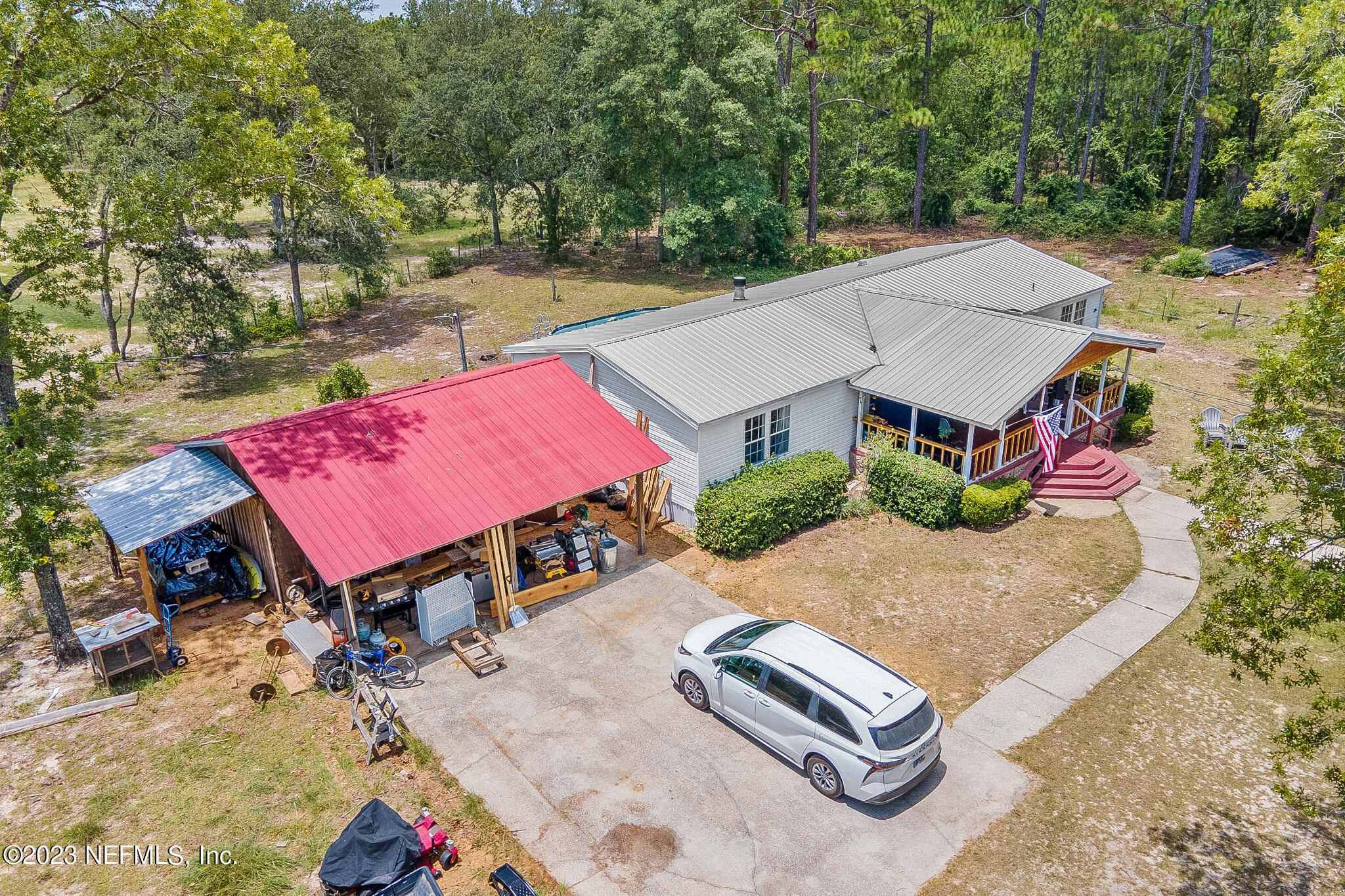 7730 Ranchette Road Keystone Heights, FL 32656 - Photo 24 of 30 an aerial view of a house with swimming pool and red space