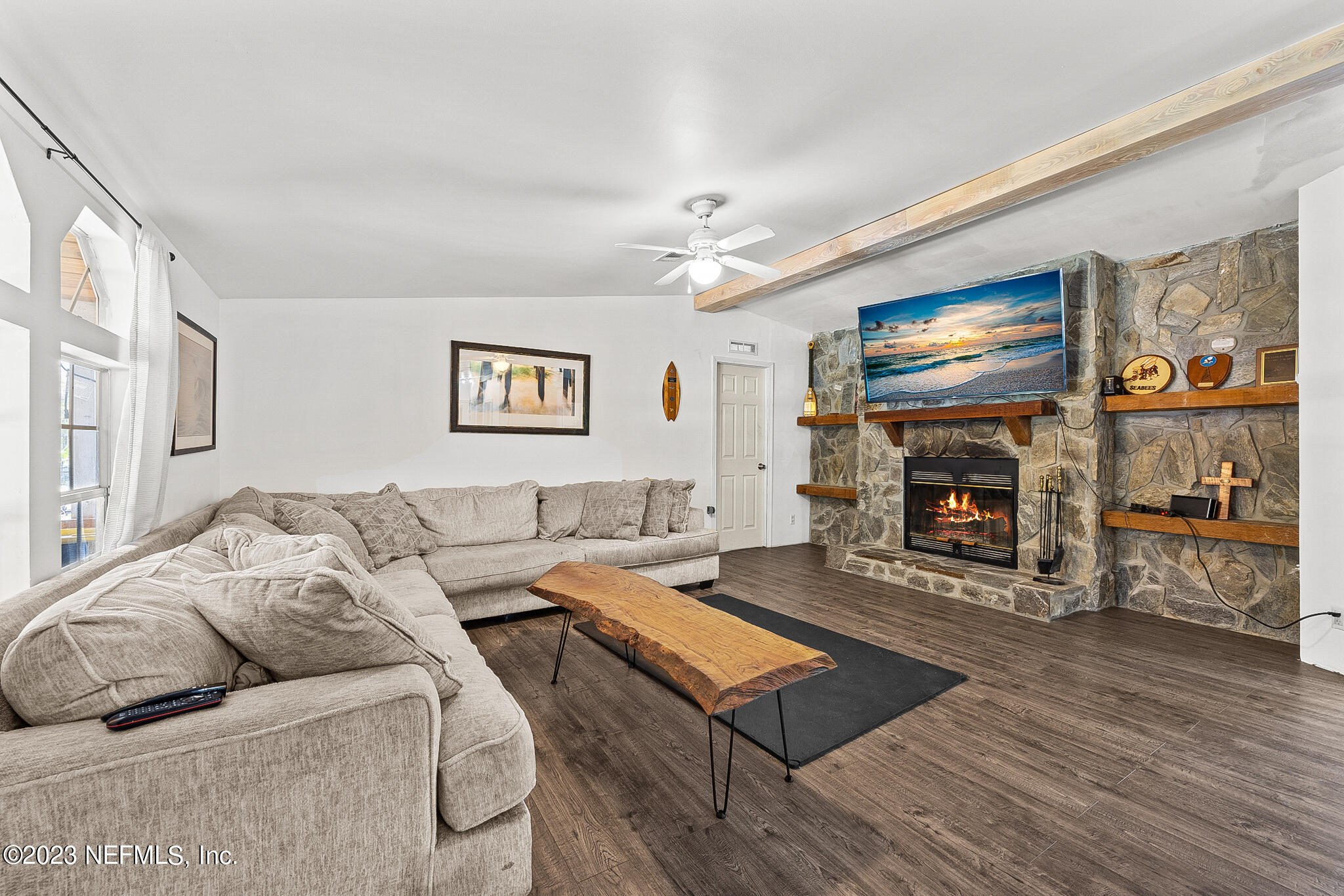 7730 Ranchette Road Keystone Heights, FL 32656 - Photo 4 of 30 a living room with furniture flat screen tv and a fireplace