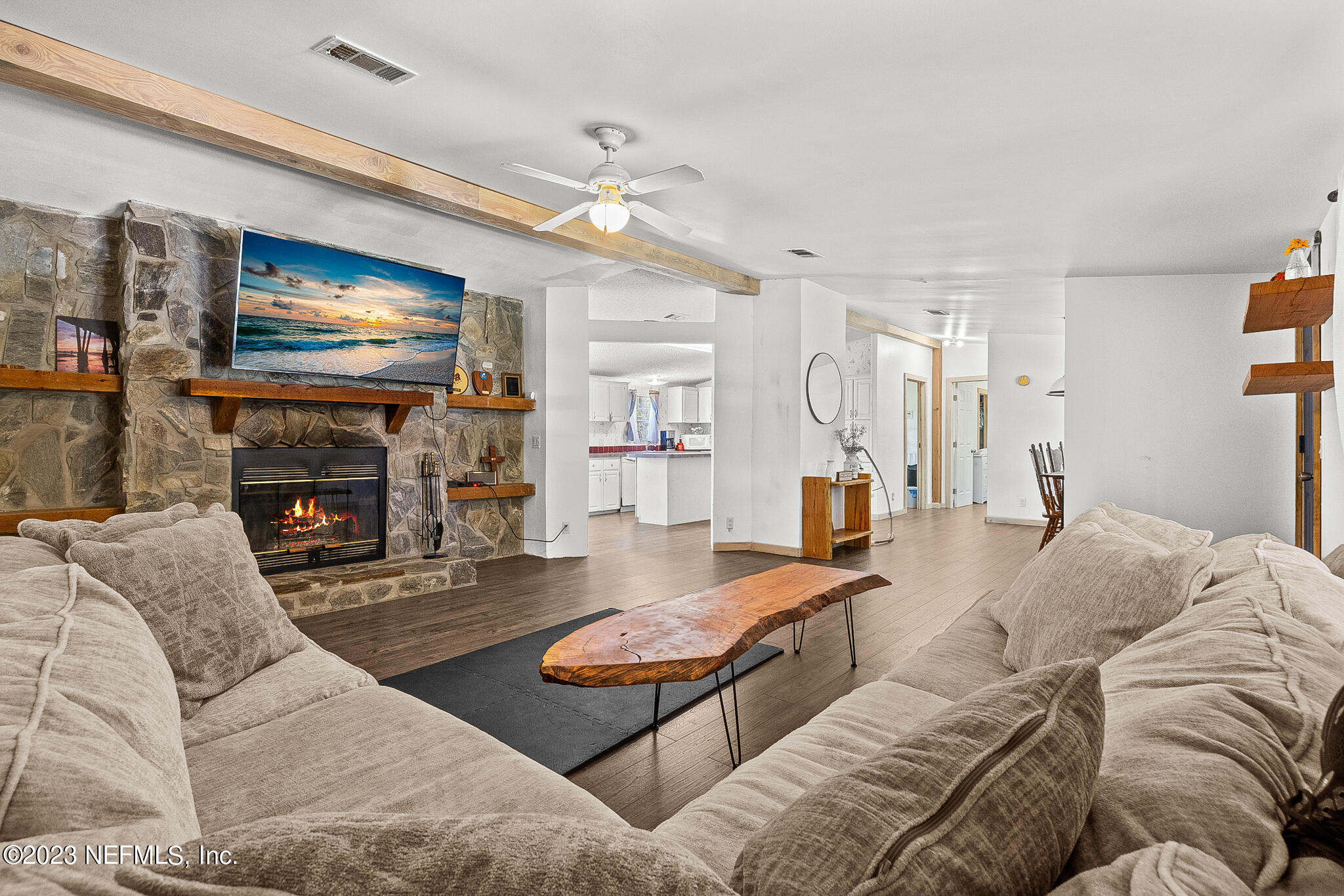 7730 Ranchette Road Keystone Heights, FL 32656 - Photo 6 of 30 a living room with furniture fireplace and a flat screen tv