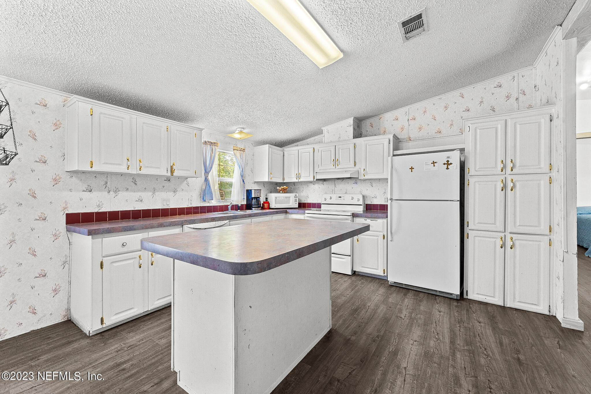7730 Ranchette Road Keystone Heights, FL 32656 - Photo 8 of 30 a kitchen with appliances a sink and a refrigerator
