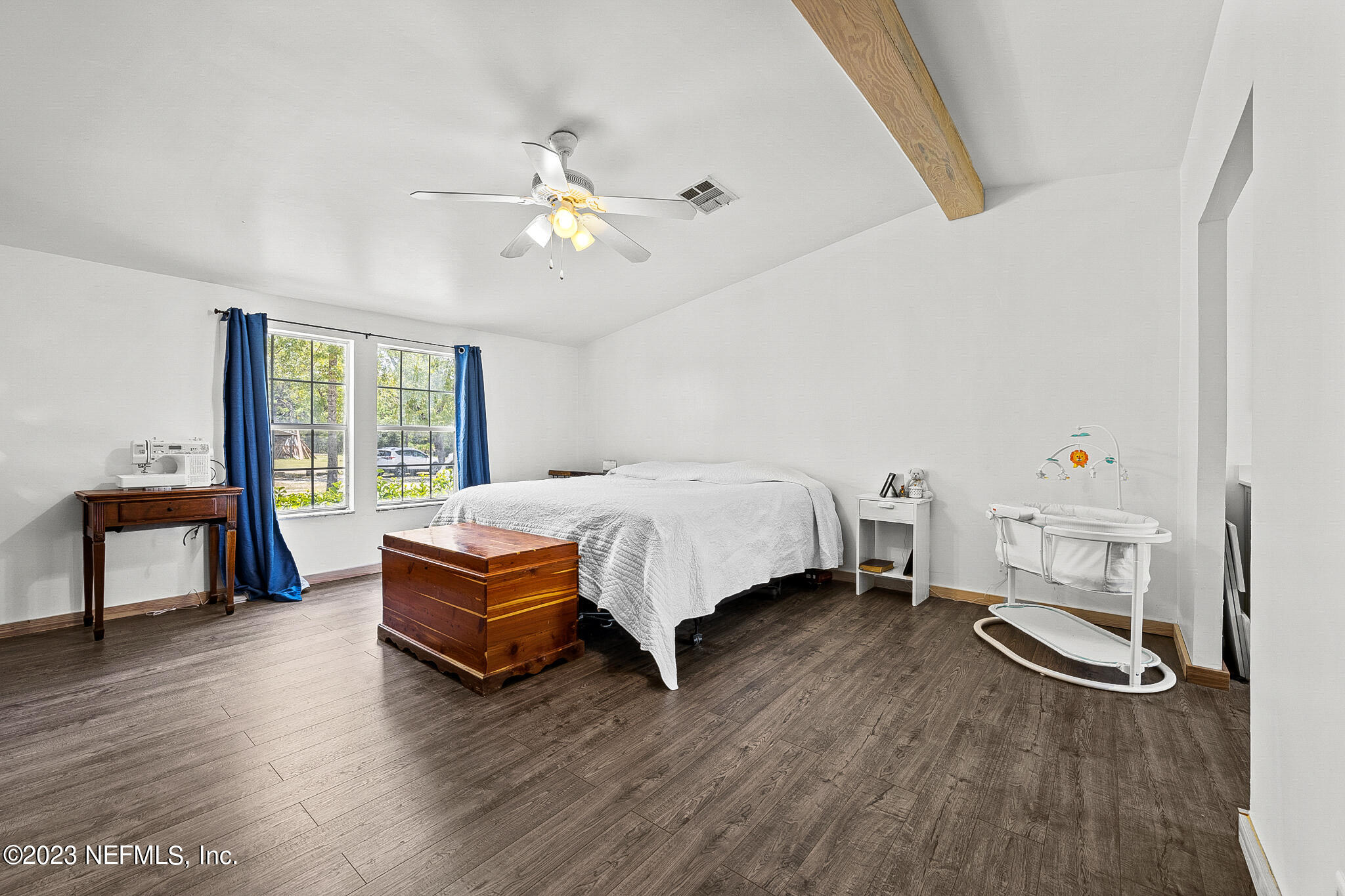 7730 Ranchette Road Keystone Heights, FL 32656 - Photo 10 of 30 a bedroom with a bed and a chandelier