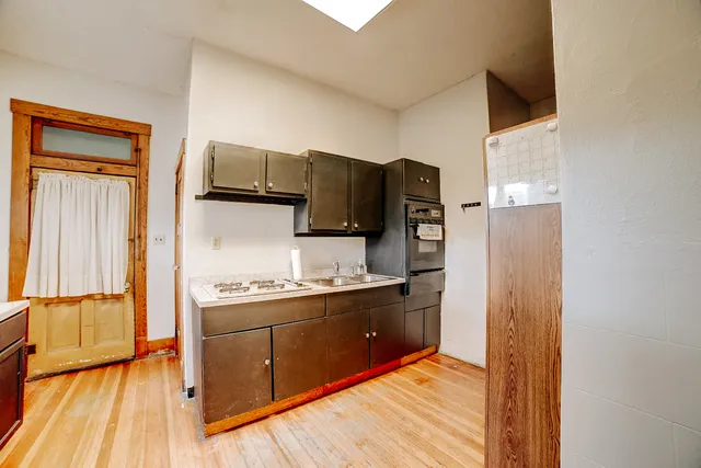 a view of a livingroom with wooden floor and a window