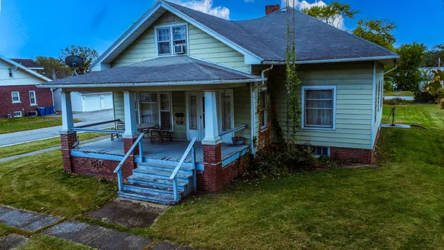 a front view of a house with a yard table and chairs
