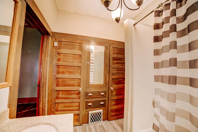 a bedroom with a bed and a potted plant