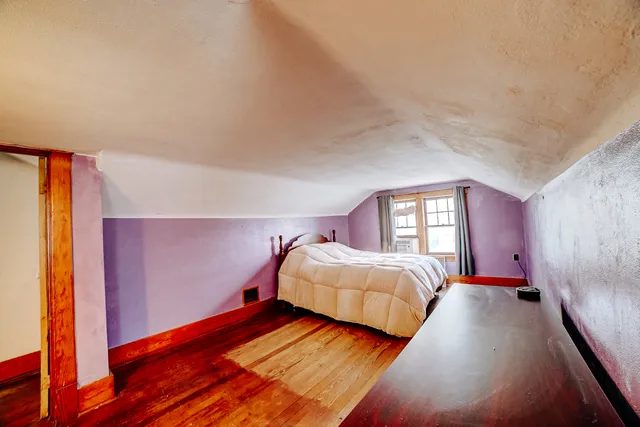 a bedroom with a bed and a night stand