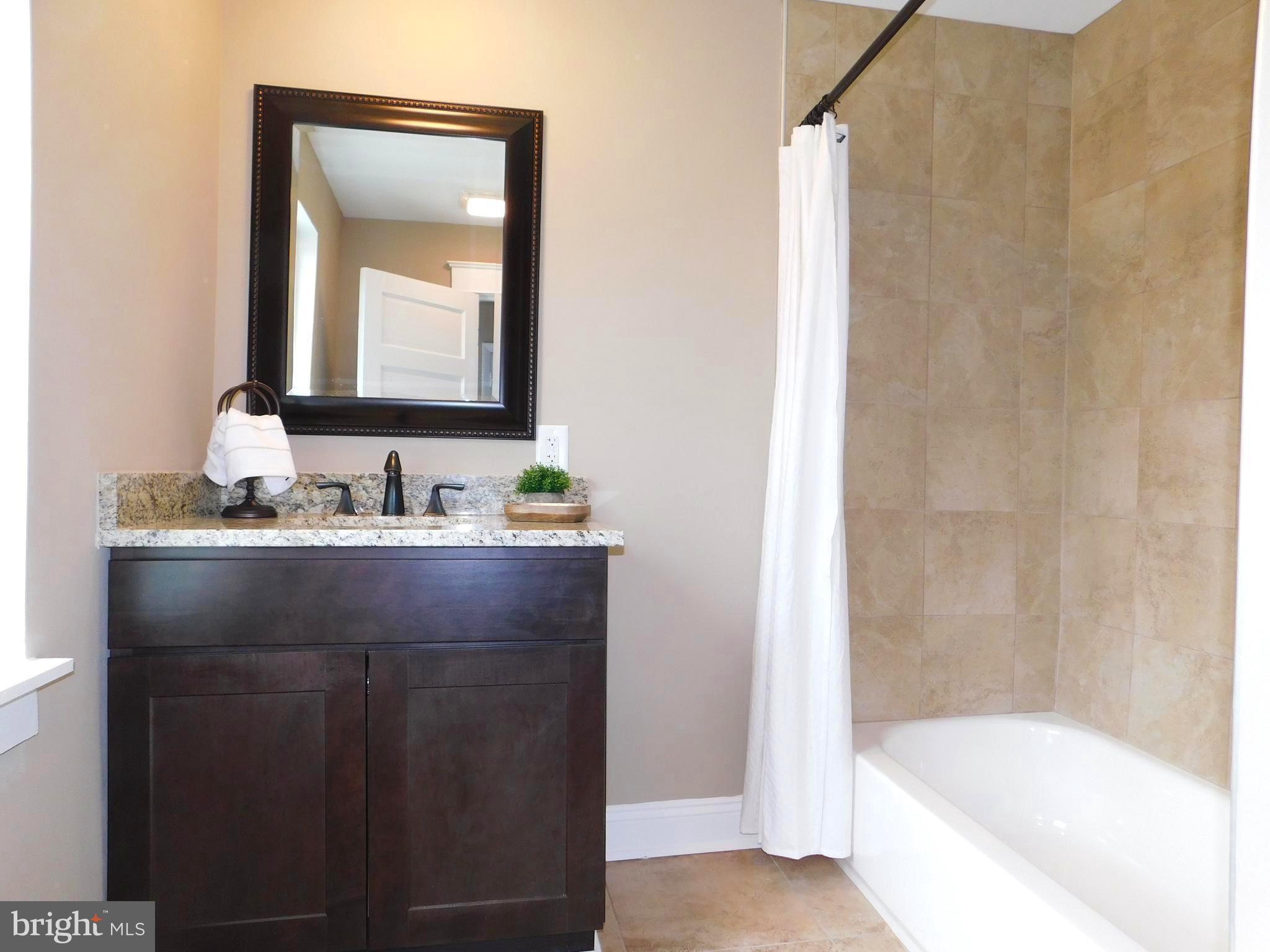 606 Andover Road Linthicum, MD 21090 - Photo 14 of 29 a bathroom with a bathtub and a sink