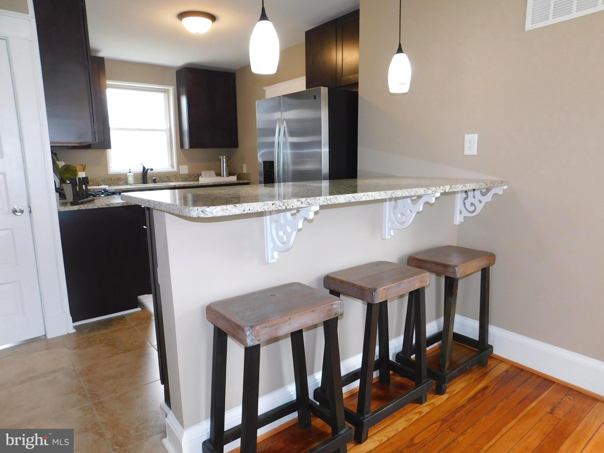 606 Andover Road Linthicum, MD 21090 - Photo 9 of 29 a kitchen with cabinets table and chairs