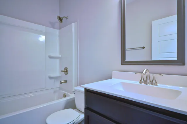 a bathroom with a sink a toilet and bathtub