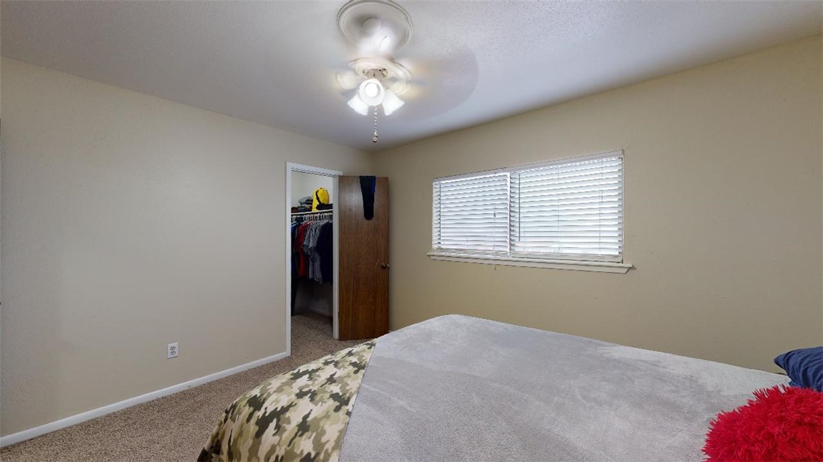 1809 Treehouse Trail, Unit D College Station, TX 77845 - Photo 17 of 23 a bedroom with a bed and a chandelier