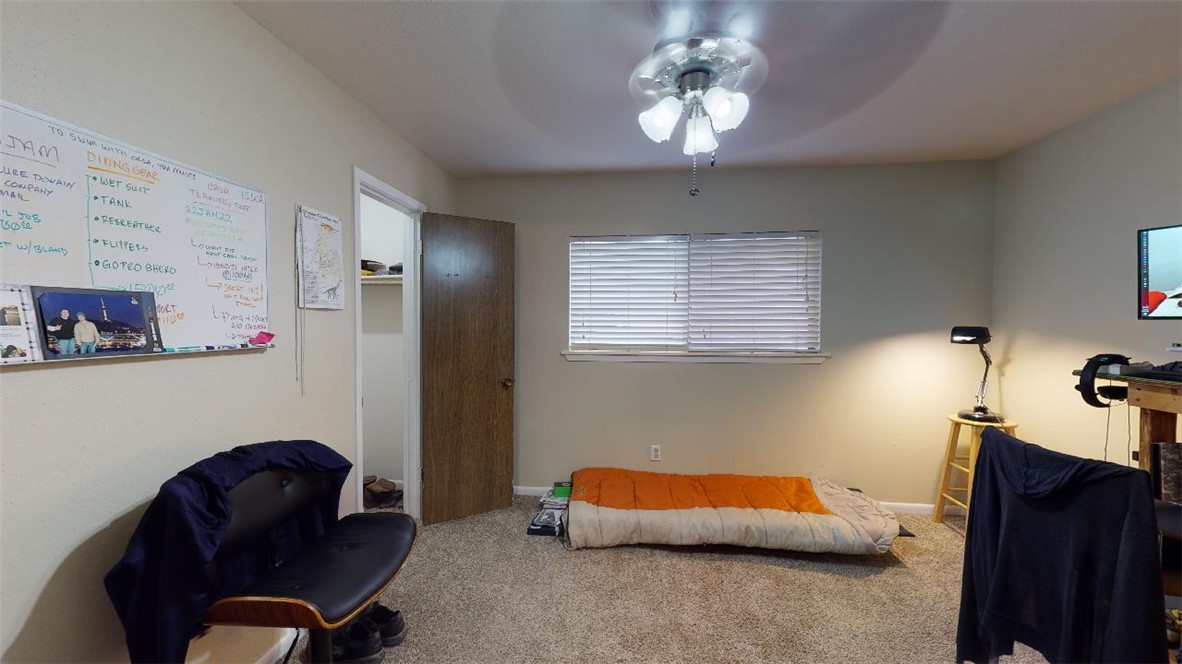 1809 Treehouse Trail, Unit D College Station, TX 77845 - Photo 20 of 23 a bedroom with furniture and a potted plant