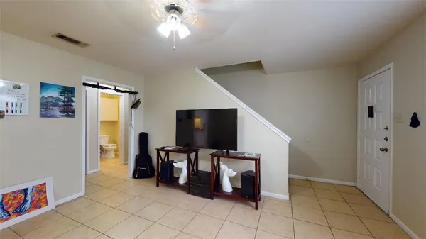 a view of a livingroom with furniture and natural light